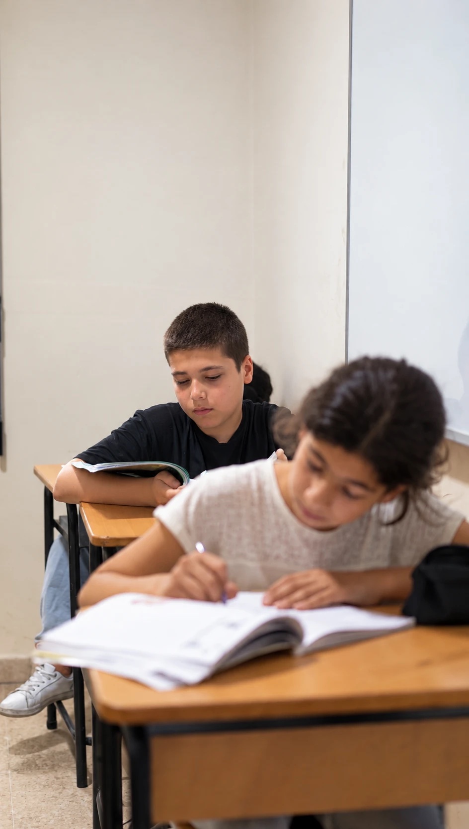 Children studying at their desks in a classroom